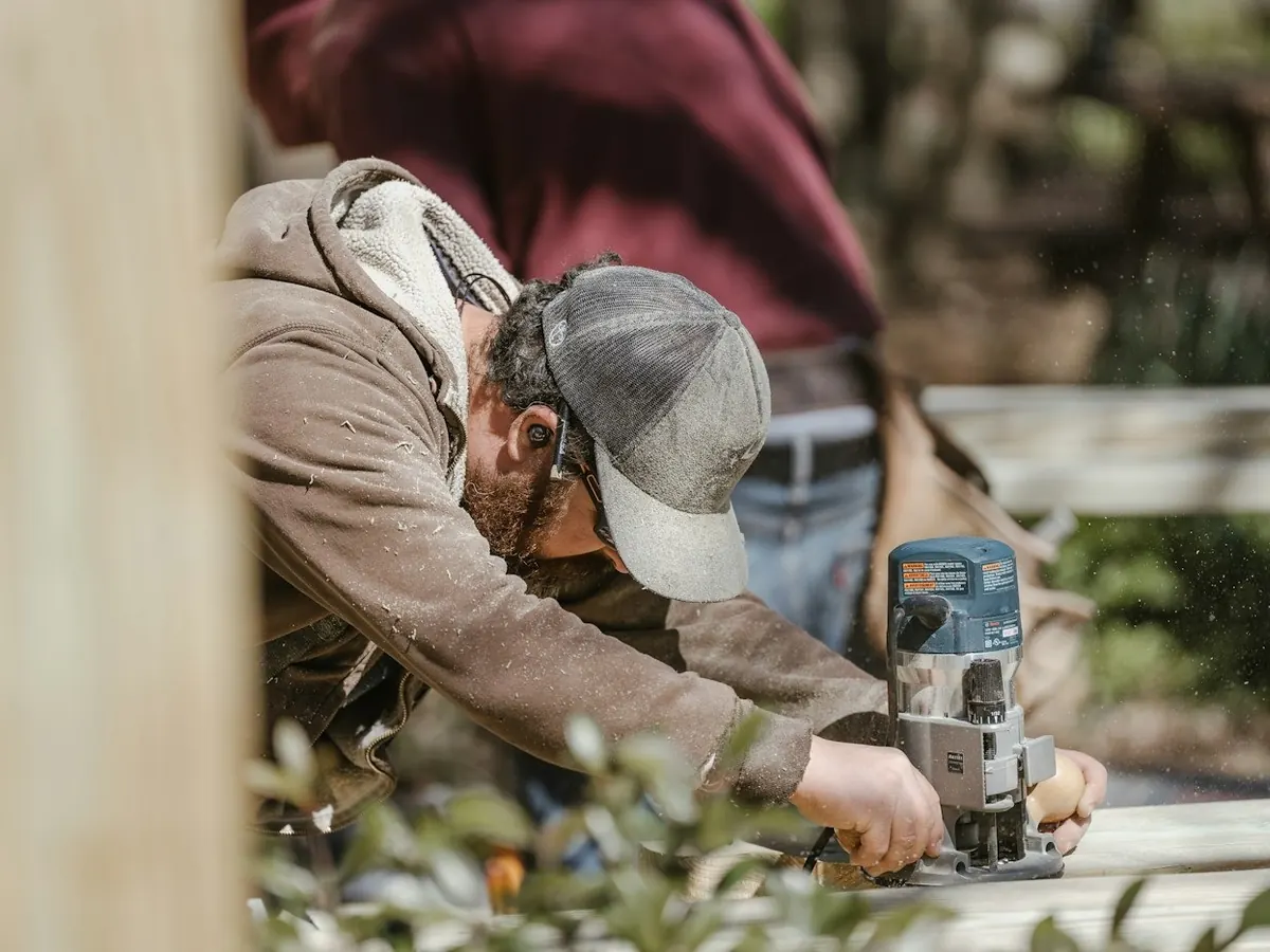 Tradesman shaping timber on site