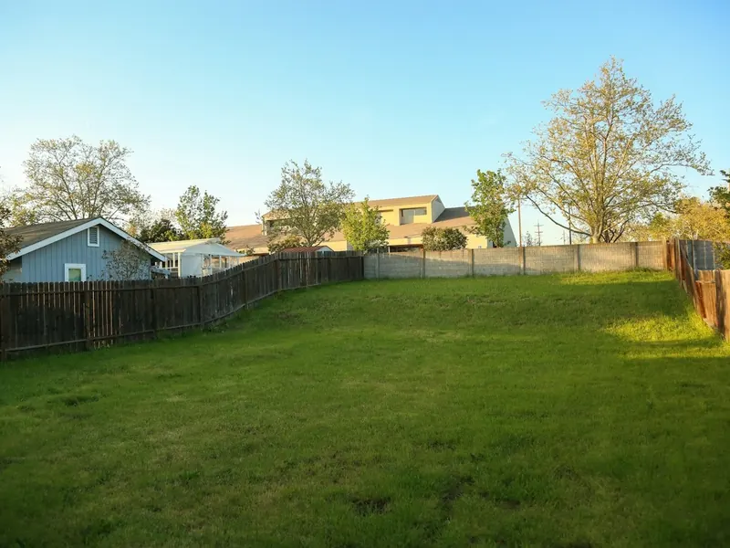 Backyard enclosed by timber paling fences